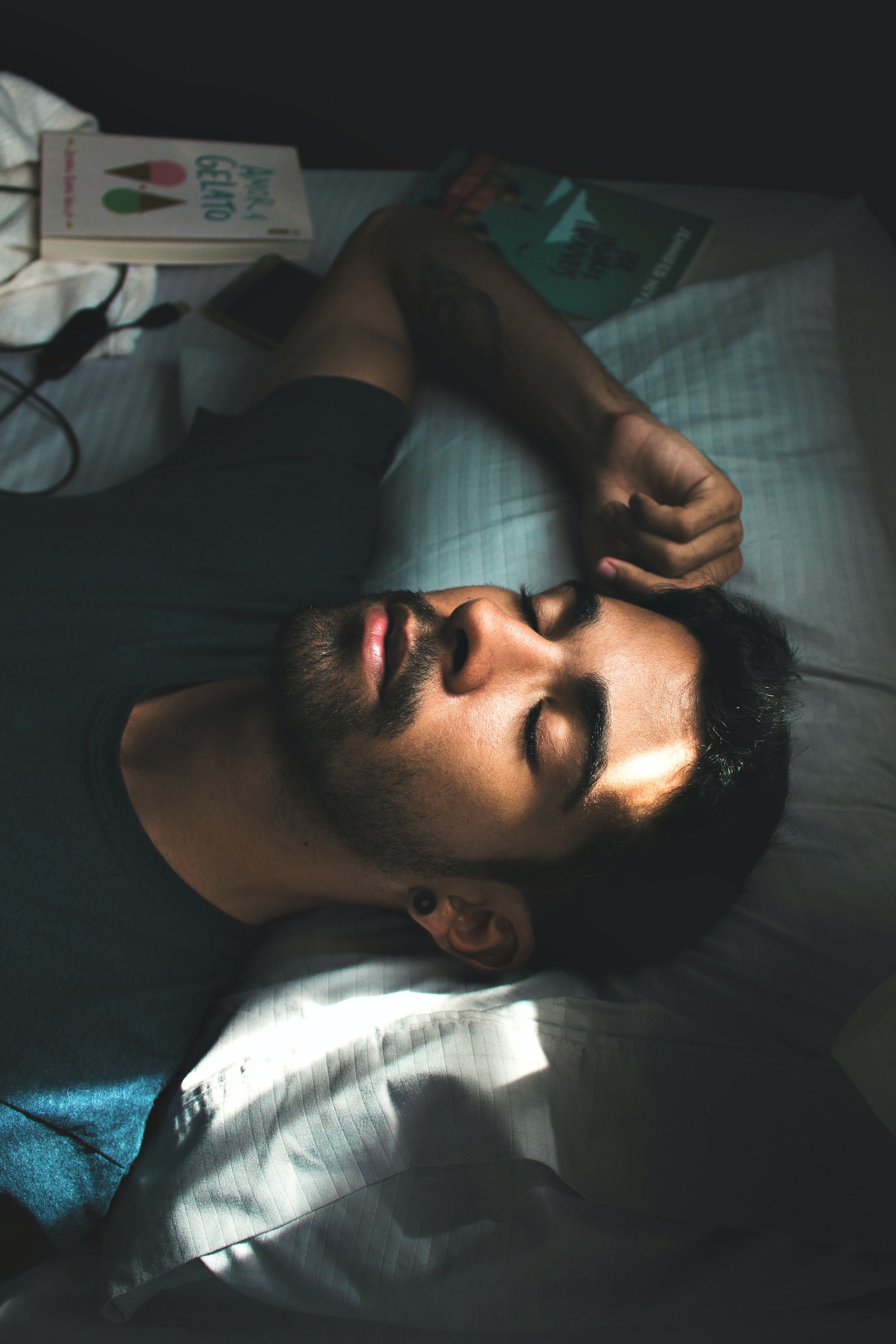 Photo by Lucas Andrade - Man sleeping on a bed