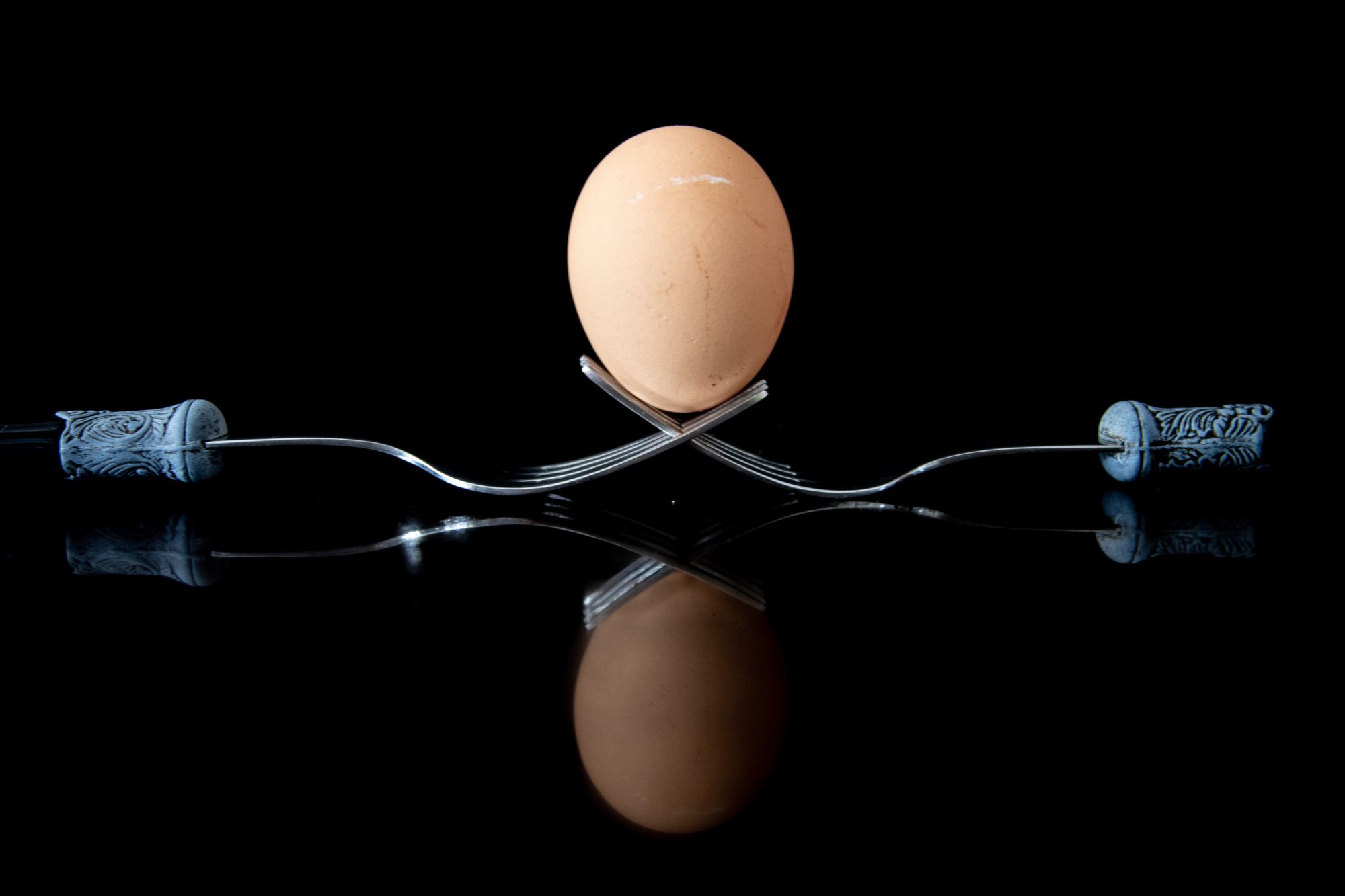 brown egg on a silver fork