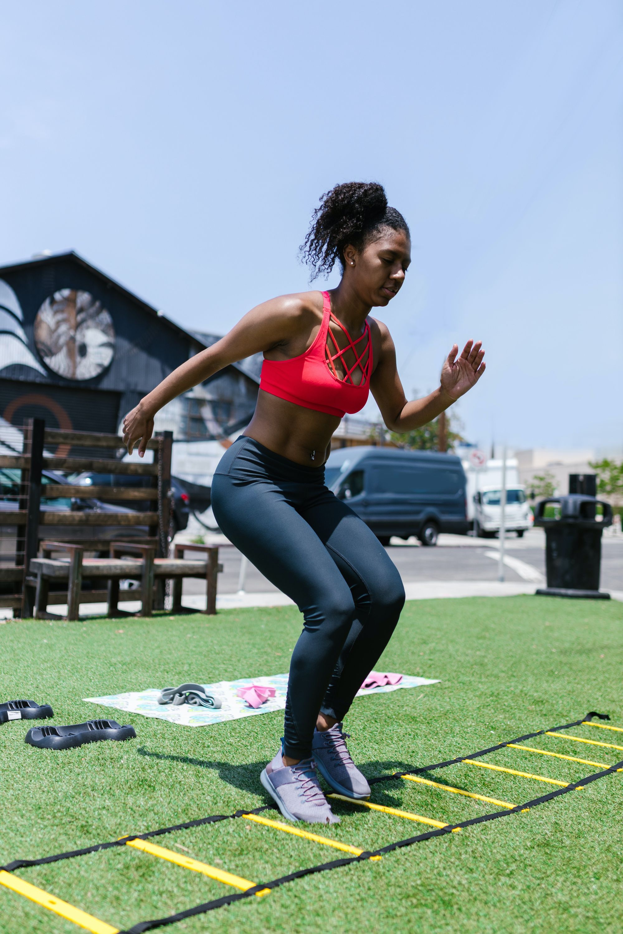 Photo by RODNAE Productions: https://www.pexels.com/photo/a-woman-in-black-leggings-using-an-agility-ladder-on-green-grass-field-8402245/