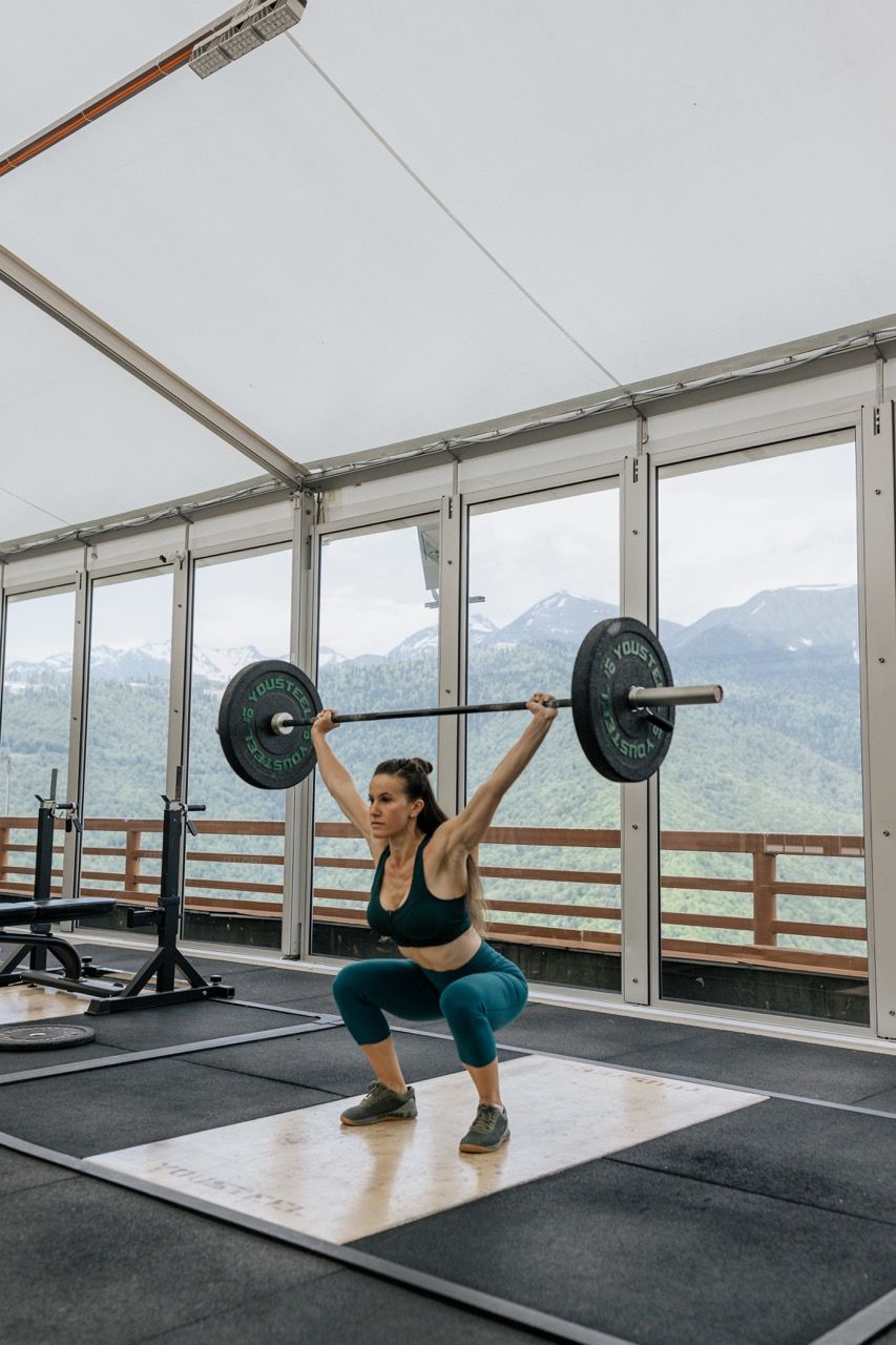 Photo by  Anastasia  Shuraeva: https://www.pexels.com/photo/woman-holding-black-barbell-beside-windows-4943914/