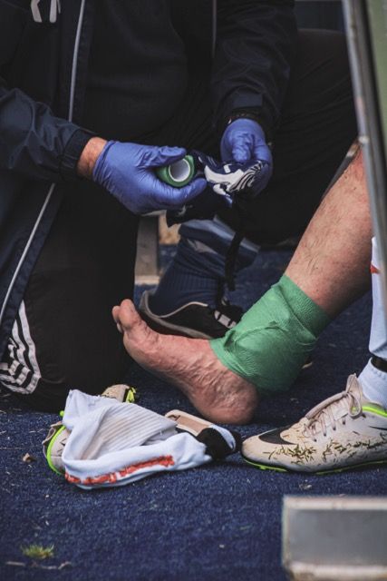 Photo by Boys in Bristol Photography: https://www.pexels.com/photo/man-helping-a-player-with-the-injury-during-the-game-12428449/