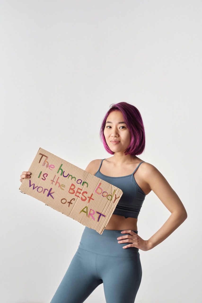 Photo by Moe Magners: https://www.pexels.com/photo/a-woman-in-activewear-holding-a-slogan-6671077/