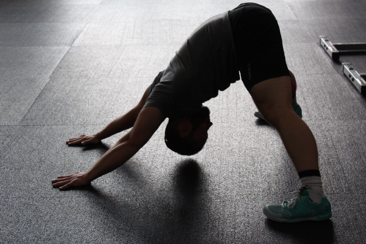 Photo by Pixabay: https://www.pexels.com/photo/man-in-grey-shirt-doing-yoga-on-gray-ceramic-tile-floor-209887/