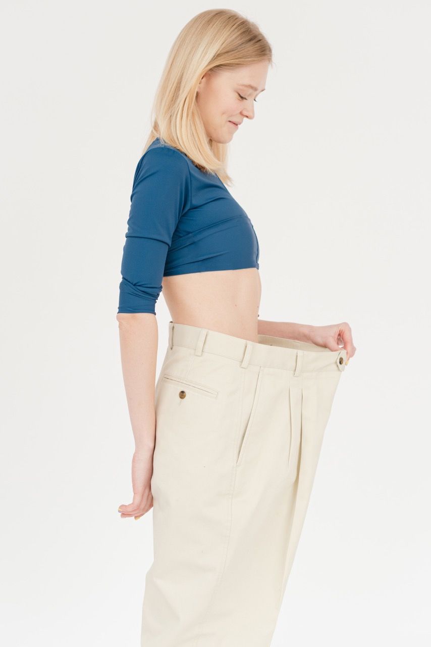 Photo by SHVETS production: https://www.pexels.com/photo/cheerful-slender-woman-in-oversized-pants-6975488/