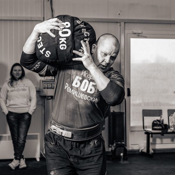 Photo by Alexa Popovich: https://www.pexels.com/photo/sportsman-carrying-heavy-bag-training-in-gym-9479166/